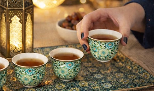 Traditional Arabic tea cups served on a decorative tray during Ramadan.